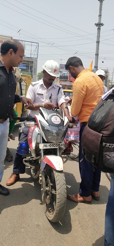 Distributing Sunstroke Medicine, water Bottles, Towels, and Health Tonic to all Traffic Police, Rickshaw Drivers, Automobiles, and common people.