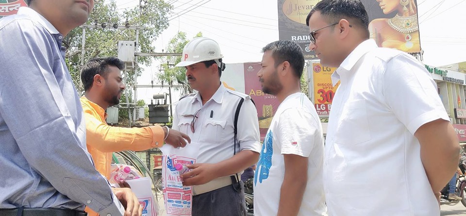 Distributing Sunstroke Medicine, water Bottles, Towels, and Health Tonic to all Traffic Police, Rickshaw Drivers, Automobiles, and common people.