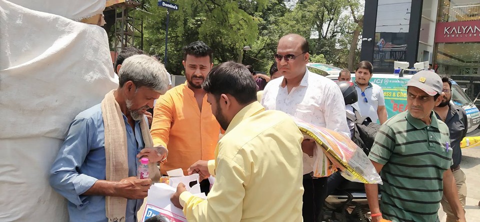Distributing Sunstroke Medicine, water Bottles, Towels, and Health Tonic to all Traffic Police, Rickshaw Drivers, Automobiles, and common people.