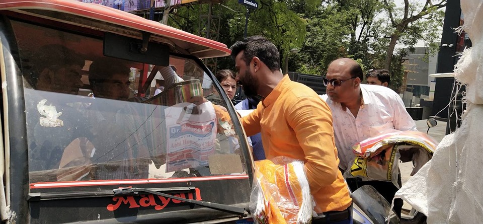 Distributing Sunstroke Medicine, water Bottles, Towels, and Health Tonic to all Traffic Police, Rickshaw Drivers, Automobiles, and common people.