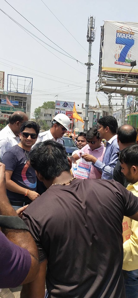 Distributing Sunstroke Medicine, water Bottles, Towels, and Health Tonic to all Traffic Police, Rickshaw Drivers, Automobiles, and common people.