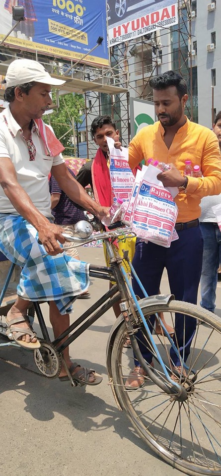 Distributing Sunstroke Medicine, water Bottles, Towels, and Health Tonic to all Traffic Police, Rickshaw Drivers, Automobiles, and common people.