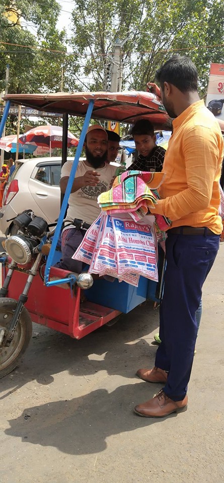 Distributing Sunstroke Medicine, water Bottles, Towels, and Health Tonic to all Traffic Police, Rickshaw Drivers, Automobiles, and common people.